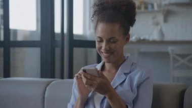 Akıllı Telefon ve Gülümseyen Kadın 'ı kullanıyoruz. Afrika kökenli Amerikalı kadın.