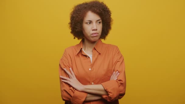 Pensive Woman Arms Crossed Yellow Background Female Negative Emotsion Slow — Stock video