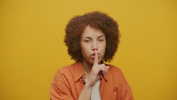Serious Woman Showing Silence Gesture Yellow Background Female Shhh Sign — Stock video