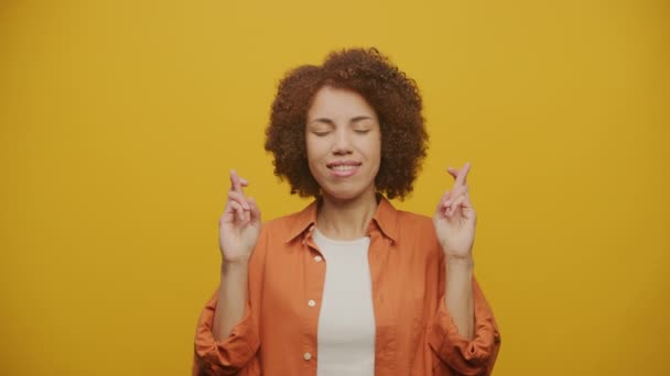 Woman Making Wish Fingers Crossed Yellow Background Female Pray Hope — Stock Video