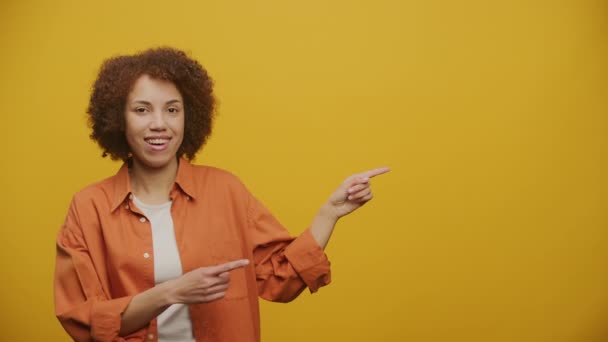 Woman Point Copy Space Looking Camera Yellow Background Female Suggestion — Stok Video