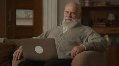 Video 'da konuşan yaşlı adam dizüstü bilgisayar kullanıyor, Kol Sandalyesi' ndeki büyükbaba konuşuyor.