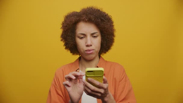 Zmatené Žena Procházení Online Smartphone Žlutém Pozadí — Stock video