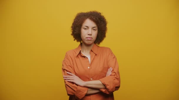 Pensive Woman Arms Crossed Yellow Background Upset Female Looking Camera — Stock Video