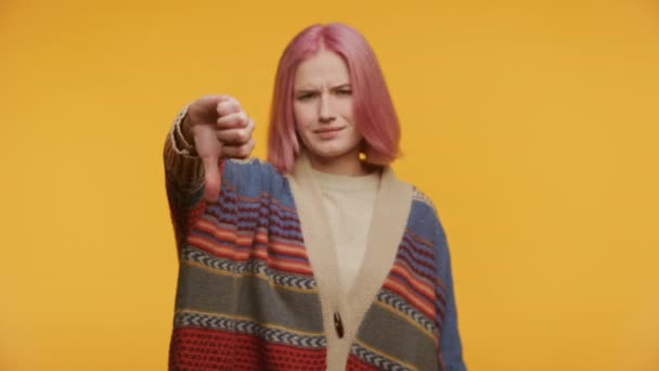 Woman Showing Dislike Gesture Yellow Background Pink Hair Youth Thumb — Stock Video