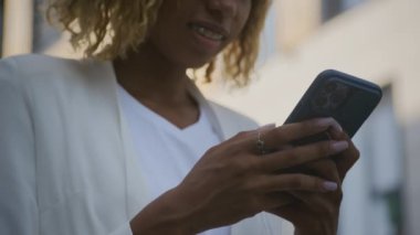 Smartphone 'da tanınmayan bir kadın dışarıda mesaj atıyor. Kapatın, dikkatli genç bir profesyonel telefonuyla meşgul. Şehir içi iletişim.