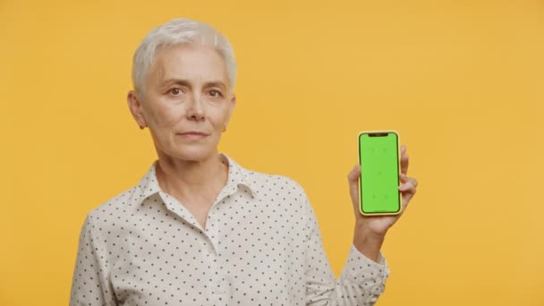 自信的老年女士推出绿色屏幕智能手机 展示了科技在老年时代的应用 老年人的数字读写能力 移动通信能力 — 图库视频影像