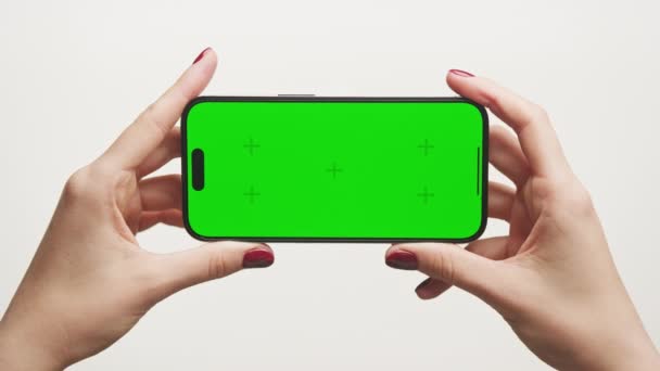Close Two Hands Holding Smartphone Horizontally Green Screen Ideal App — Stock Video