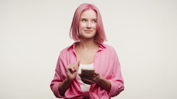 Uma Jovem Mulher Com Cabelo Rosa Moda Sorri Sutilmente Enquanto — Vídeo de Stock