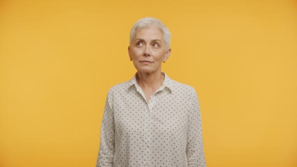 Elderly Woman Crossed Fingers Eyes Closed Making Wish Vivid Yellow — Stock Video