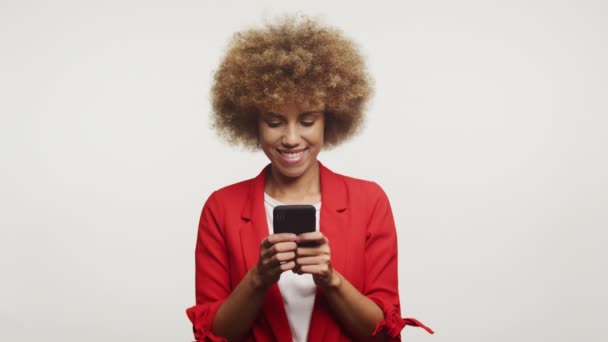 Femme Utilisant Joyeusement Téléphone Vêtue Rouge Sur Fond Blanc — Video