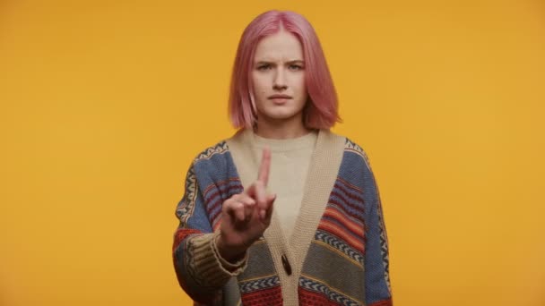 Pinkhaarige Frau Strickkleidung Gestikuliert Mit Dem Zeigefinger Vor Einem Leuchtend — Stockvideo