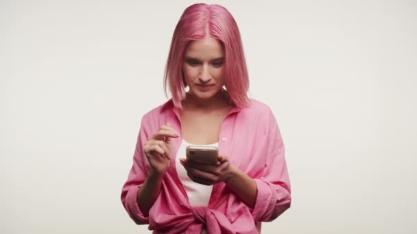 Verrast Jonge Vrouw Met Roze Haar Reageren Inhoud Haar Smartphone — Stockvideo