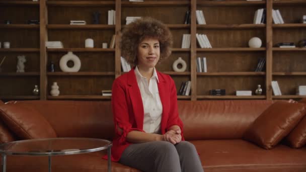 Lächelnde Frau Roten Blazer Sitzt Selbstbewusst Stilvollem Büroambiente — Stockvideo