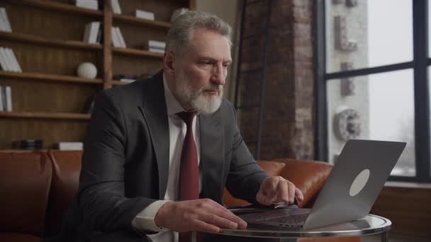 Homme Affaires Sénior Concentré Sur Ordinateur Portable Dans Loft Moderne — Video