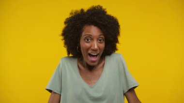 Yeşil bluzlu neşeli bir kadının portresi pozitif bir şok ifadesi sergiliyor..