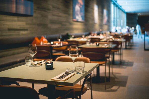 Chic Scandinavian Ambiance Cozy and Elegant Dining Interior Restaurant in Oslo With Glasses on the table