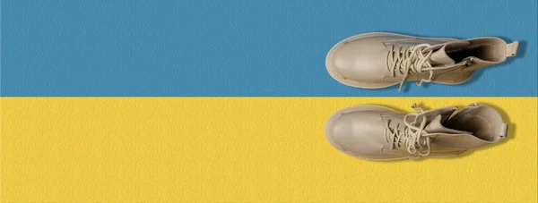 beige women\'s shoes on a yellow-blue background. Autumn shoes. Banner for insertion into site. Horizontal image