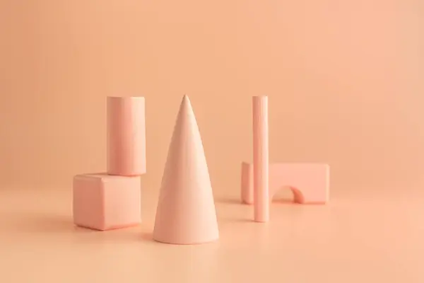 stock image Set of geometric shapes on table colored in Peach Fuzz - color of the year 2024.