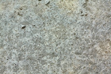 Yıpranmış betonun pürüzsüz dokusu doğal pürüzleri ve küçük çukurları gösteriyor. Mimari altyapı için ideal.