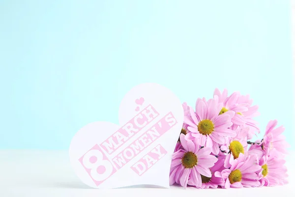 花束和心形卡片 蓝色背景的3月8日妇女日 免版税图库照片