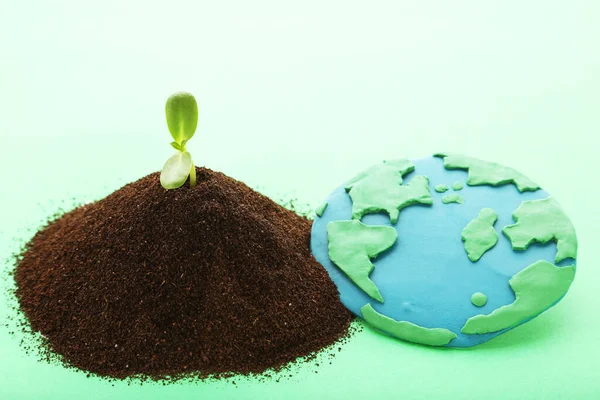 Earth Day Concept Green Sprout Growing Out Soil Plasticine Planet Stockbild