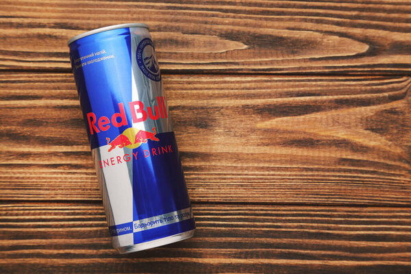 MYKOLAIV, UKRAINE - JANUARY 15, 2021: Can of Red Bull drink on wooden background