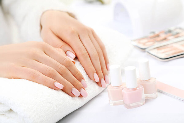 Beautiful woman hands with manicure tools