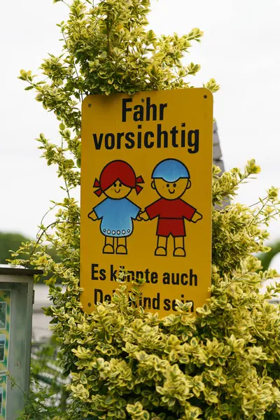 stock image Warning sign in German that informs about being careful on the road in connection with children