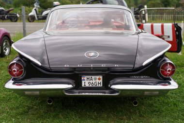 Iserlohn Gruermannscheide, NRW, Germany. 13th of July 2024. Black vintage Buick Electra Invicta on green grass. Rear view clipart