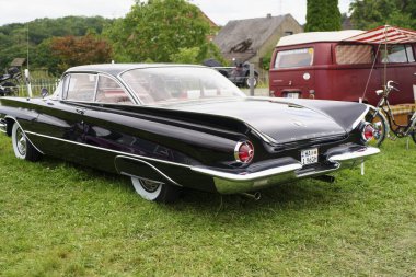 Iserlohn Gruermannscheide, NRW, Germany. 13th of July 2024. Black vintage Buick Electra Invicta on green grass clipart