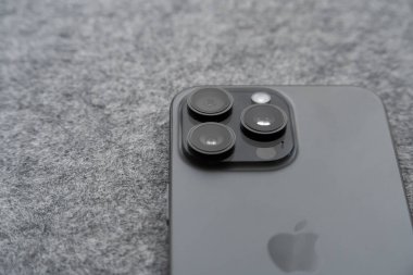 Iserlohn, NRW, Germany. February 23, 2025. Macro image of the backside of an Apple iPhone 15 Pro Max lying on a table. clipart