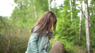 Yoğun ormandaki küçük tatlı kız. Arka plan bulanık. Çocukluğun yavaş video konsepti