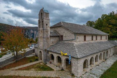 Aerial view of Agios Athanasios stone built  church during  fall season in the stone  village Monodendri central Zagori Greece