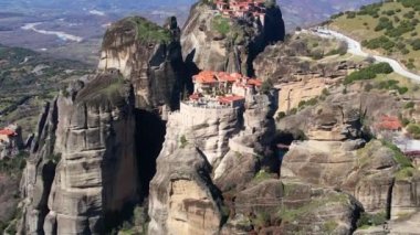 Aerial drone video of the monasteries of  Varlaam, the great Meteoro and the st Nickolaos  an unesco world heritage site,  located on a unique rock formation  above the village of Kalambaka 