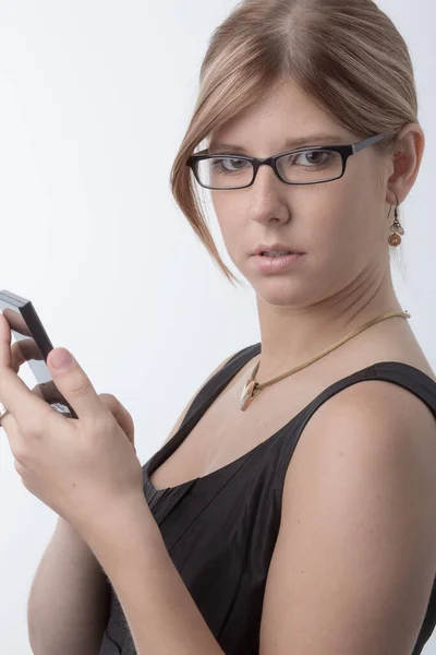 Young worried woman with a calculator is checking numbers or energy costs