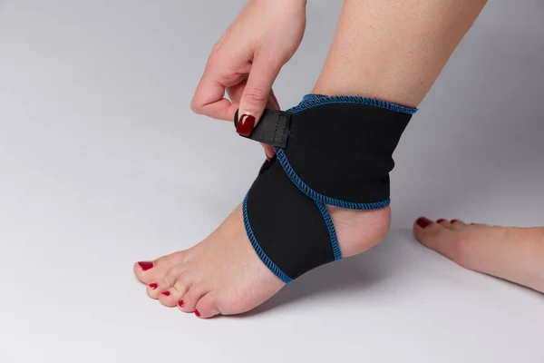 Close Woman Foot Fixing Ankle Bandage — Stock Photo, Image