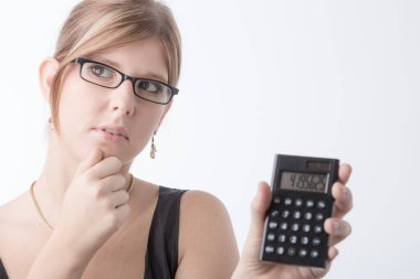Young woman is presenting her calculator and looks very worried