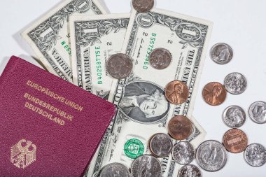 travelling with money: american dollars in bills and coins and a passport