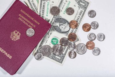 travelling with money: american dollars in bills and coins and a passport