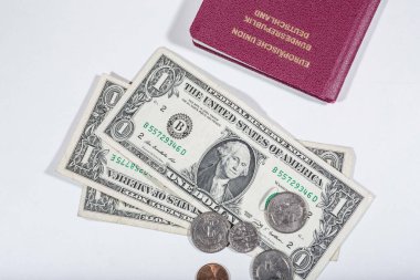 travelling with money: american dollars in bills and coins and a passport