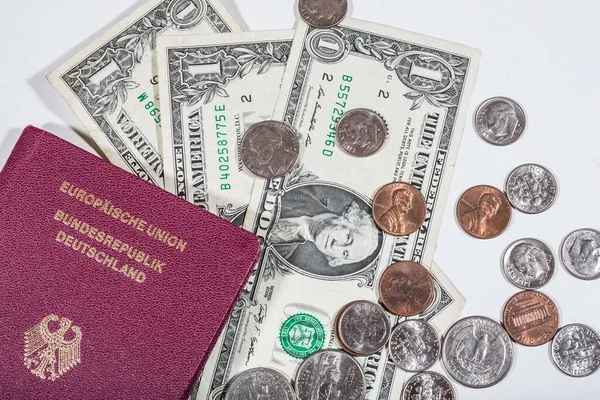 travelling with money: american dollars in bills and coins and a passport