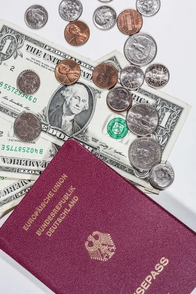 travelling with money: american dollars in bills and coins and a passport