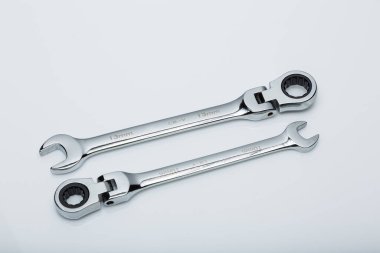 two wrenches on a white surface