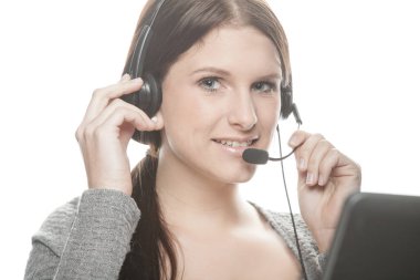 young woman with headset works as a friendly call center agent