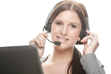 close-up of young woman with headset works as a friendly call center agent