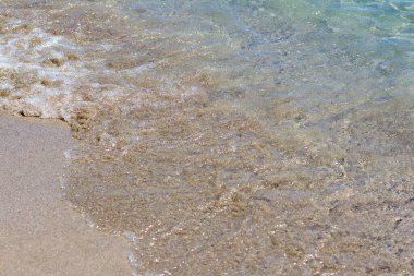 Sandy seashore with gentle waves