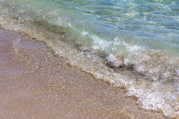 Sandy seashore with gentle waves