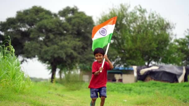 Cute Little Indian Kid Holding Waving Running Tricolour Greenery Background — Stock Video
