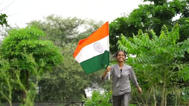 Cute Young Indian Girl Holding Waving Running Tricolour Greenery Background — Stock Video